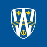 Shield-shaped logo with white and blue sections featuring yellow crosses and anchor symbols
